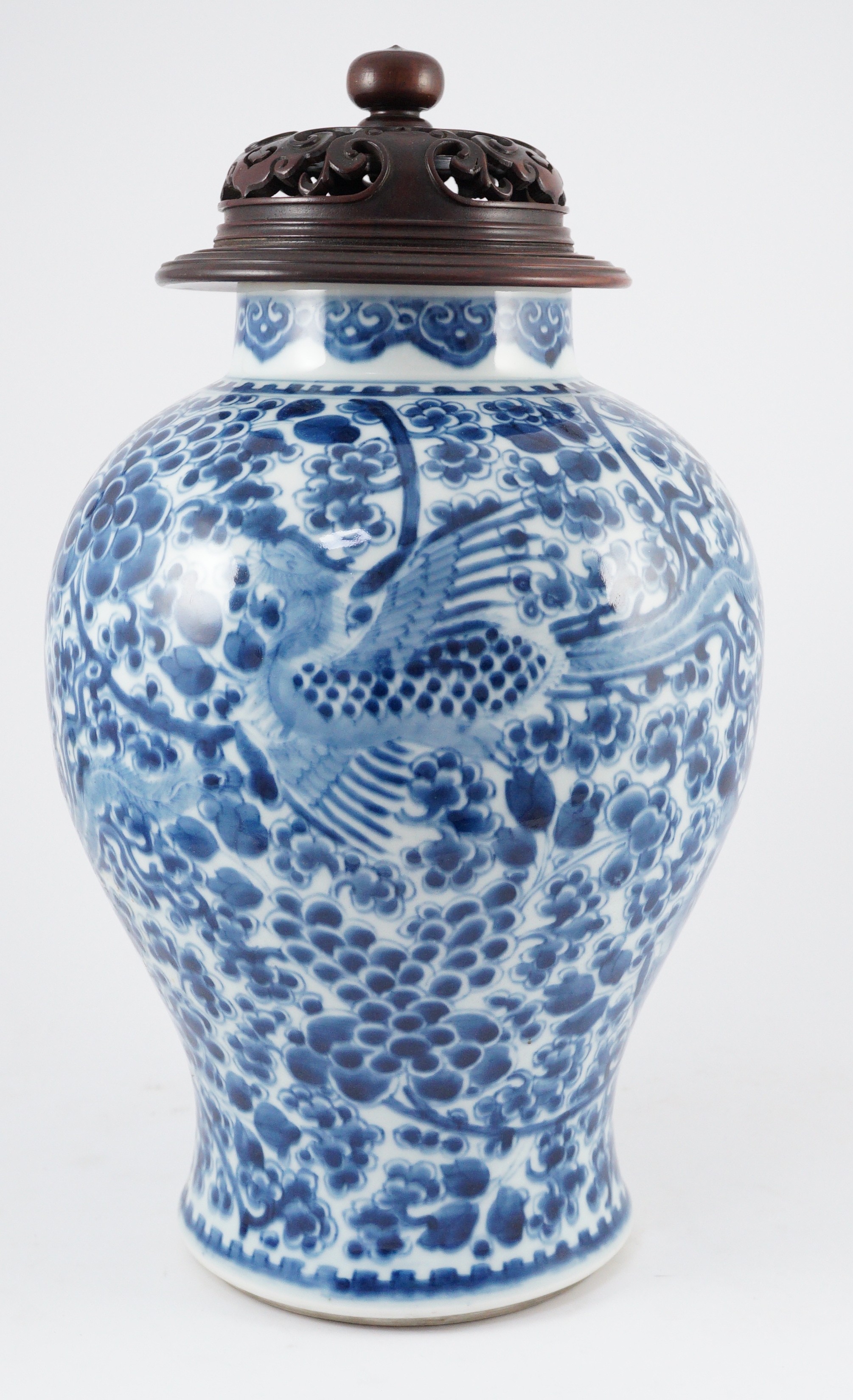 A Chinese blue and white ‘phoenix and peony’ baluster jar, Kangxi period, with a later wood cover, 36cm high excluding later wood cover